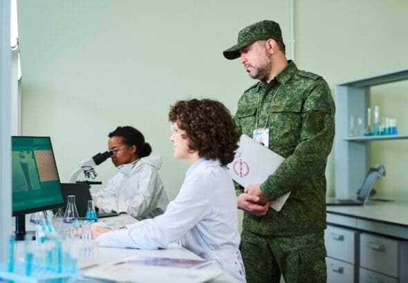 Mature,Man,In,Camouflage,Uniform,Standing,By,Female,Clinician,While