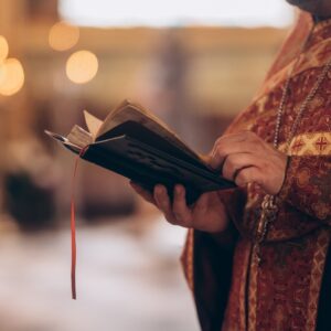 Close-up,Of,An,Orthodox,Priest's,Hands,Holding,The,Bible,During